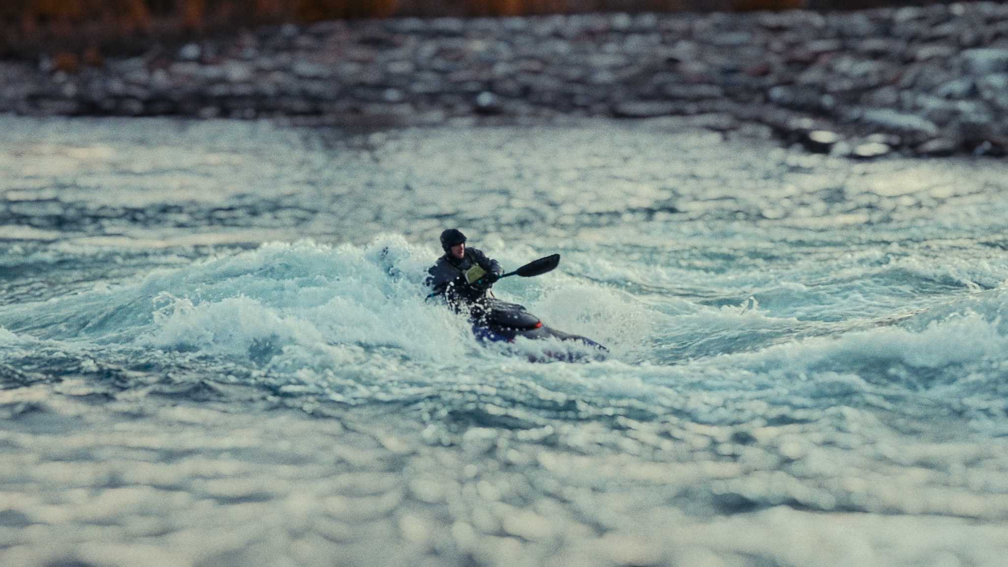 Whitewater packraft running turbulent Class IV rapids in the Canadian Rockies